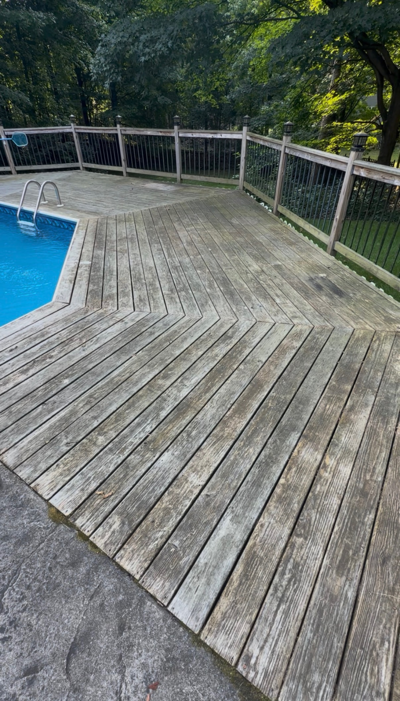 Weathered wood pool deck washed, sanded and sealed — before