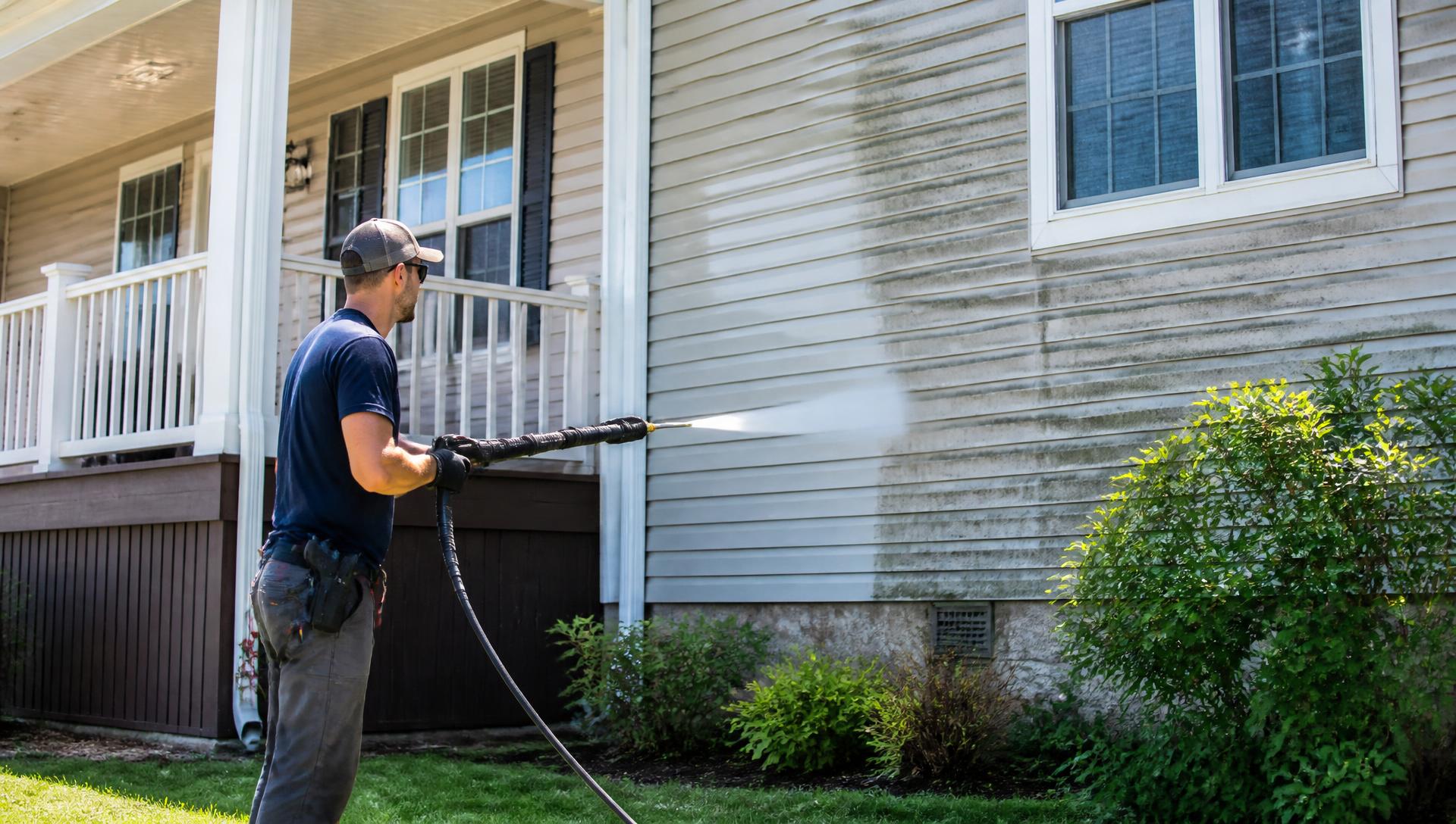 Professional pressure washing of a home exterior in Syracuse, New York
